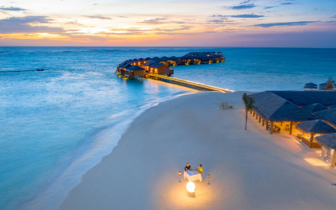 Goa beach sunset with golden sky and waves on the shore
