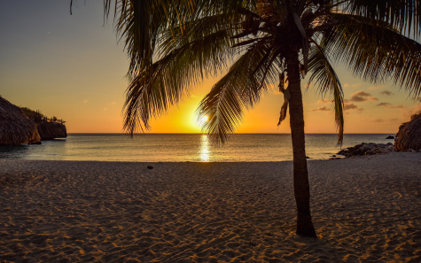 Tourists enjoying sunset at Baga Beach with beach shacks in Goa Tours Packages