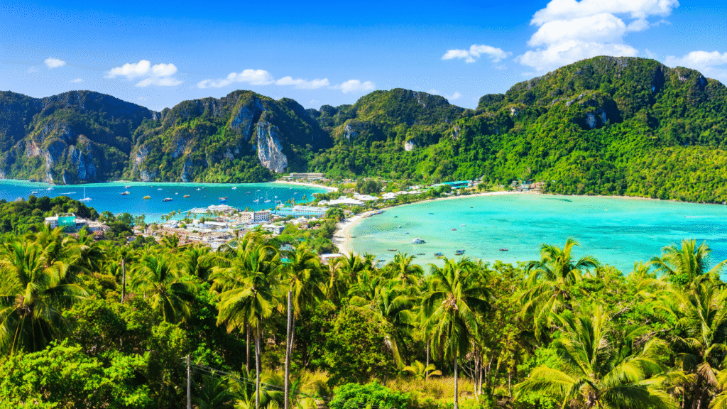 Phi Phi Island cliffs and turquoise waters featured in Thailand Tour Packages